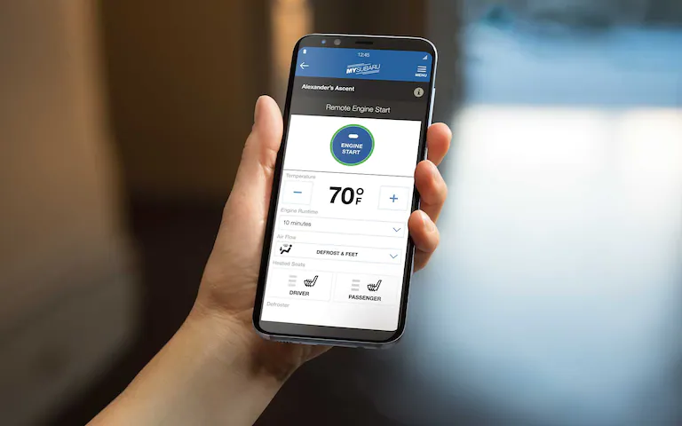 A close-up of a smartphone showing the Remote Engine Start with Climate Control feature available on the Subaru Ascent