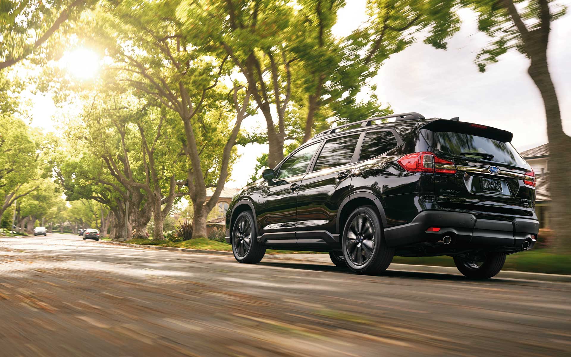 A Subaru Ascent Onyx Edition driving through a neighborhood.