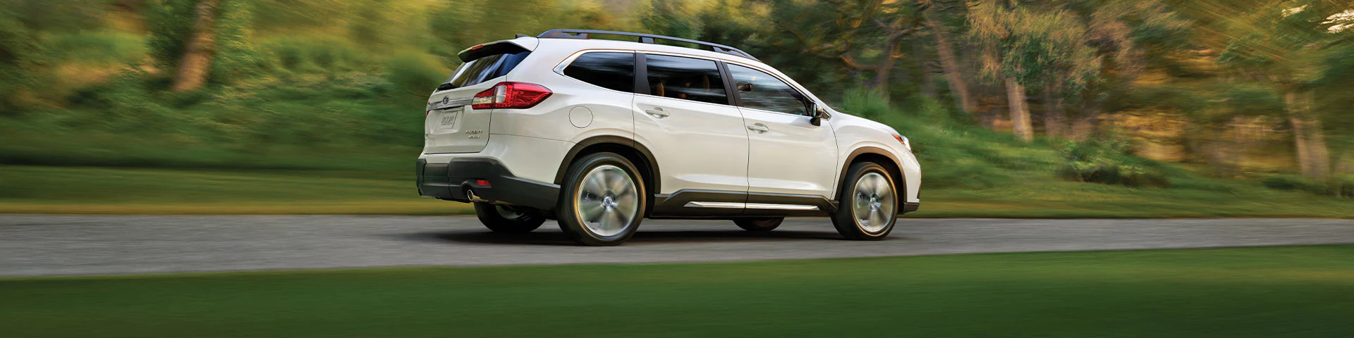 A Subaru Ascent driving on a country highway.