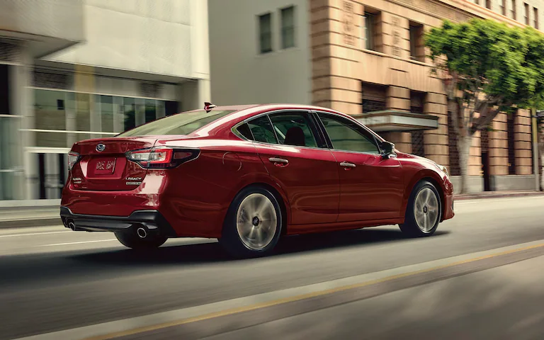 A 2022 Subaru Legacy Touring XT driving on a city street.