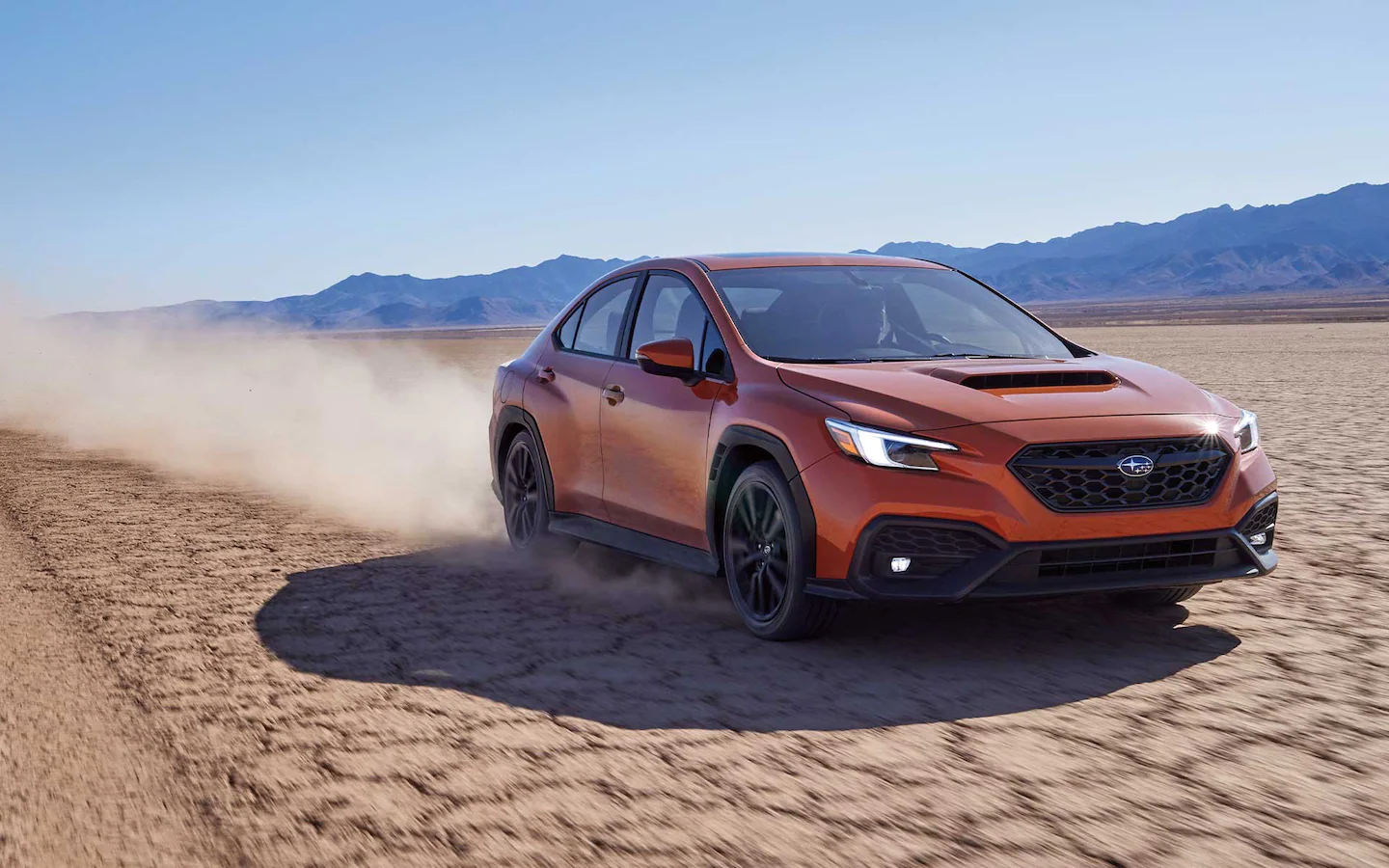 The 2022 Subaru WRX driving down a desert highway.